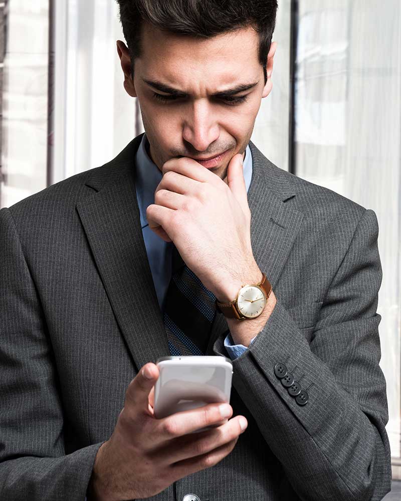 Confused man looking at phone